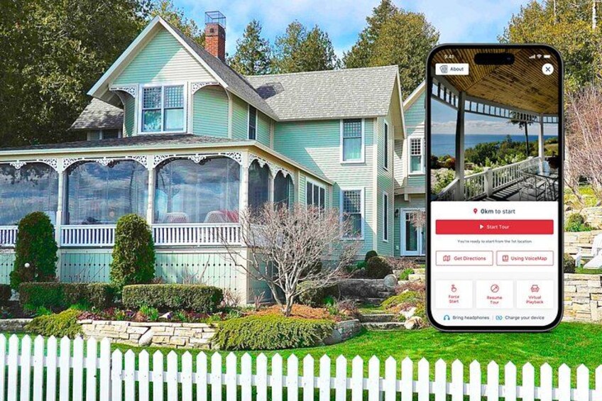A two-story house with a porch, surrounded by a white picket fence, and a smartphone displaying a map application. 1