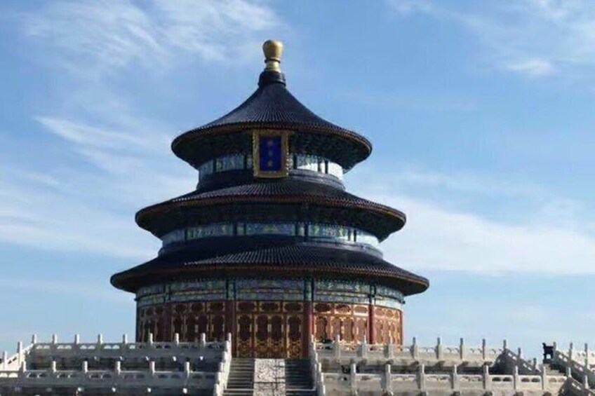 A traditional Chinese pagoda with multiple tiers, a golden roof, and a blue and gold gate. 3