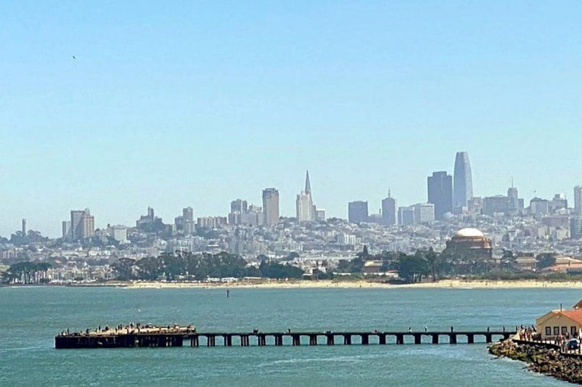 A coastal city skyline with a pier extending into the water. 2