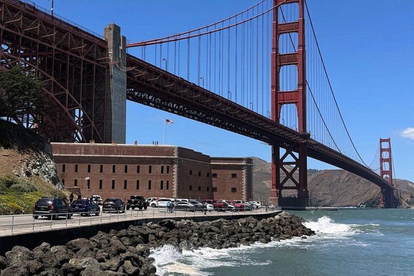 A suspension bridge, a building, and a rocky shoreline. 5