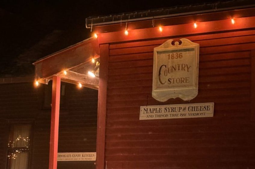 A wooden building with a sign reading '1836 Country Store' and 'Maple Syrup & Cheese.' 2