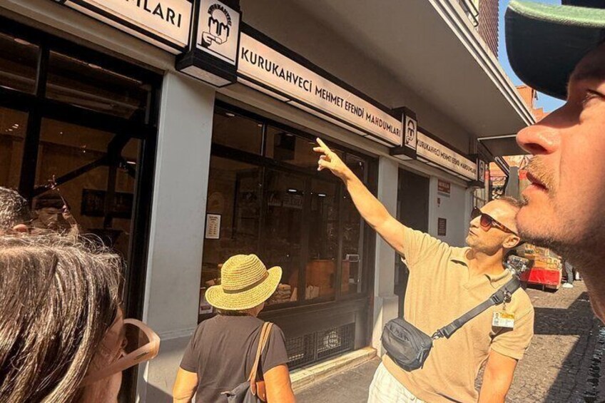 A street scene with a shop named 'KURUKAHVECI MEHMET EFENDI MARDUMLAR'. 4