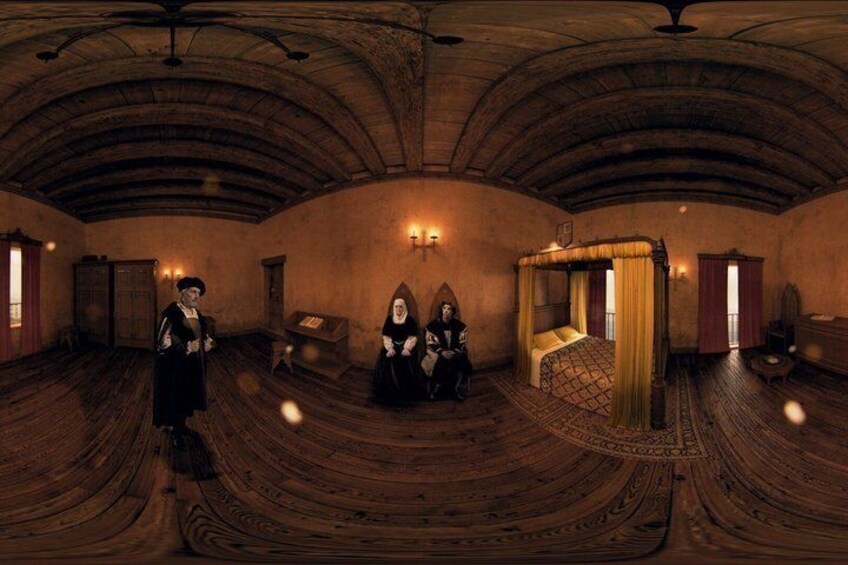 A room with a wooden floor, a bed with a canopy, and a person standing. 2