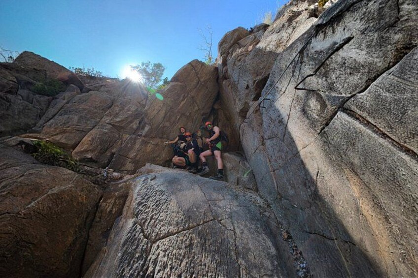 A group of people climbing a rocky mountain. 3