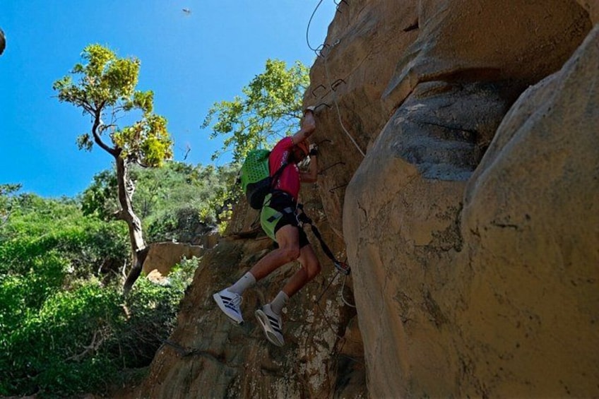 A person climbing a rock face. 2