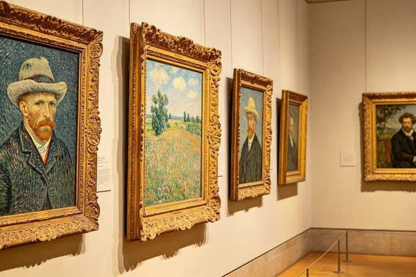 A gallery with paintings on display, framed in ornate gold and brown. 4