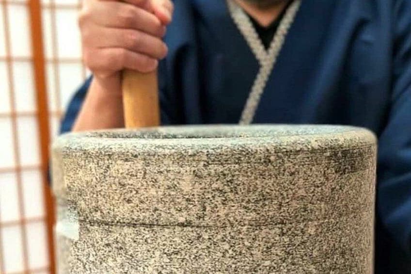 A person using a mortar and pestle. 1