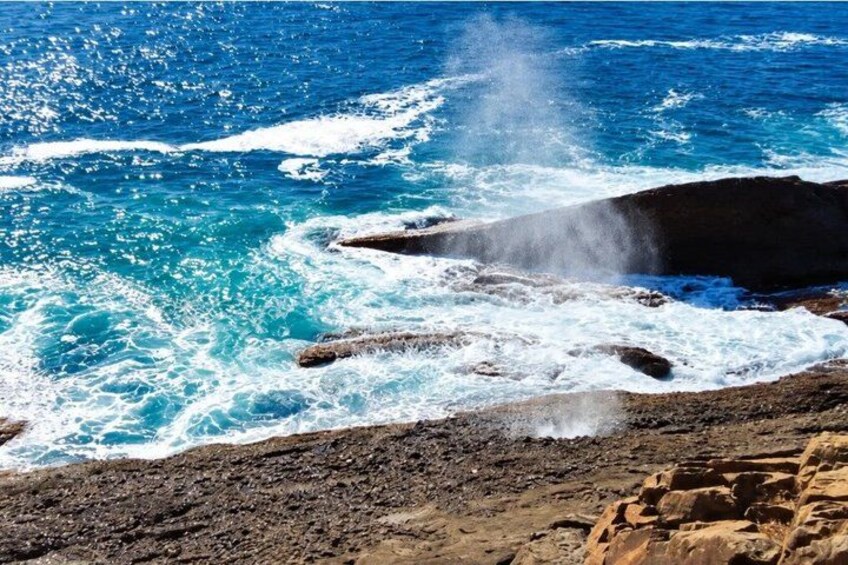 A rocky coastline with waves crashing against the rocks. 1