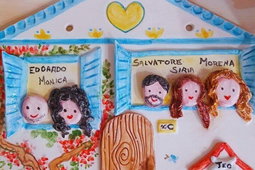 A decorative house with names and faces on the windows. 2