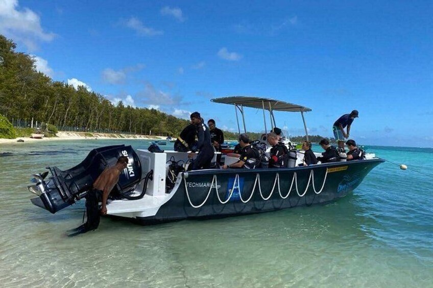 A boat with people on a clear day near a beach. 3