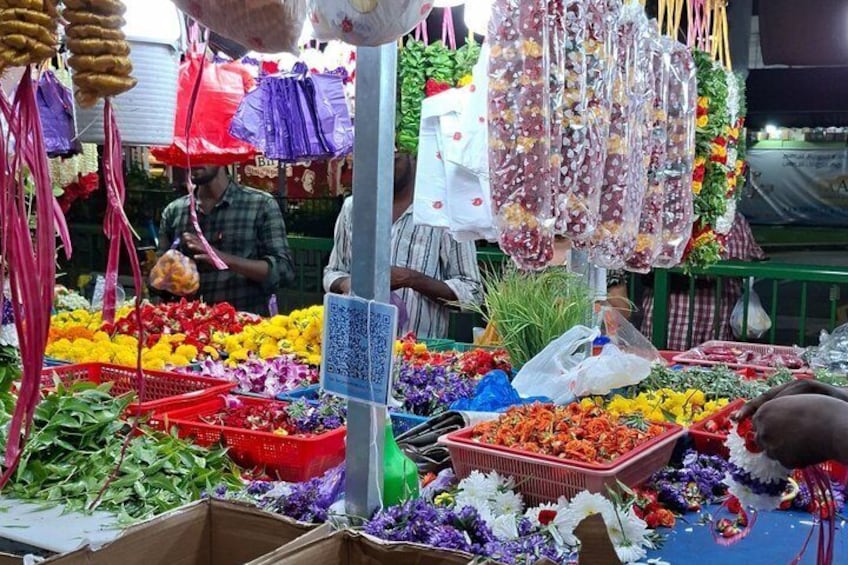 A flower market with various flowers and baskets. 4