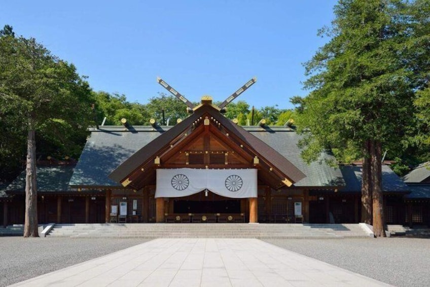 A traditional Japanese building with a tiled entrance and a large banner. 2