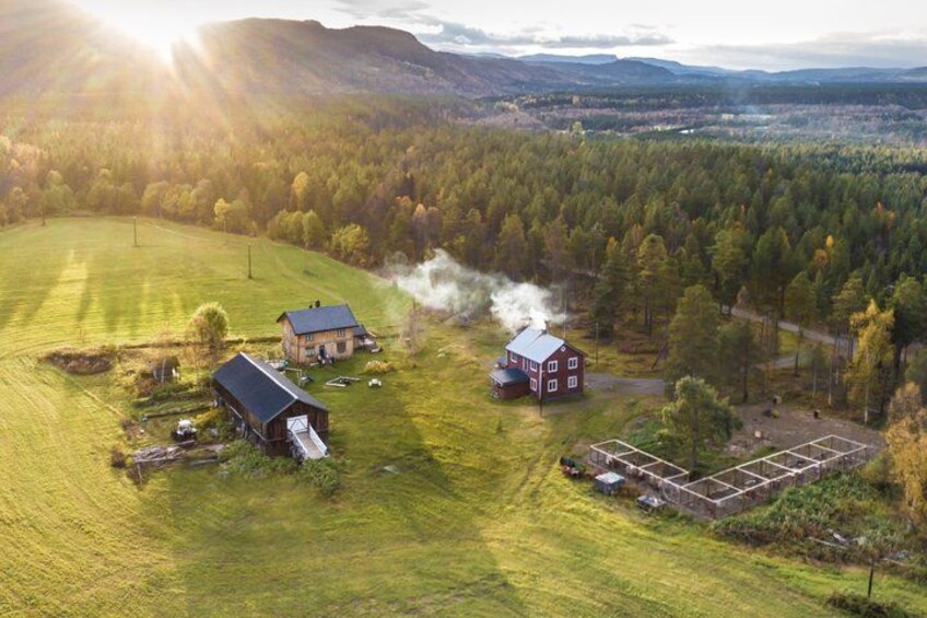 A rural landscape with a barn, a silo, and a house emitting smoke. 4