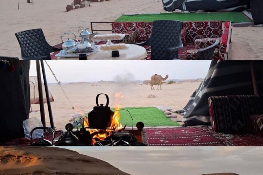 A tent, a table with a kettle, and a camel in the background. 1