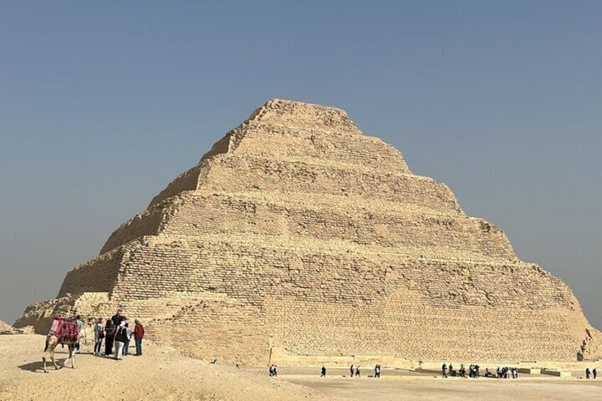 A large pyramid with tourists around it. 2