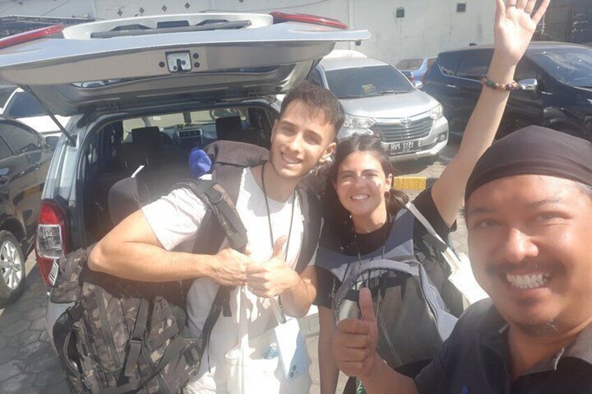 A group of people with backpacks in a vehicle with an open trunk. 5
