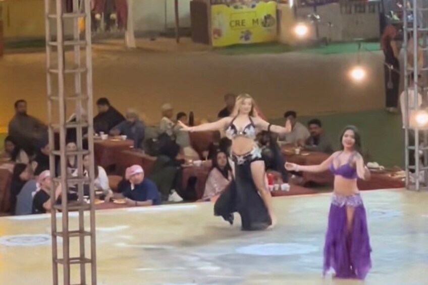 A stage with two dancers performing. 2