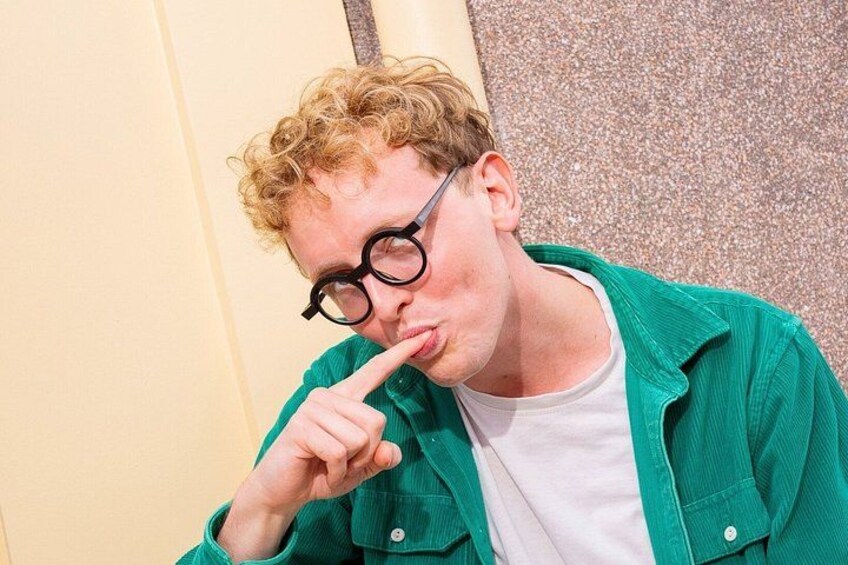 A person wearing a green jacket and a white shirt. 2