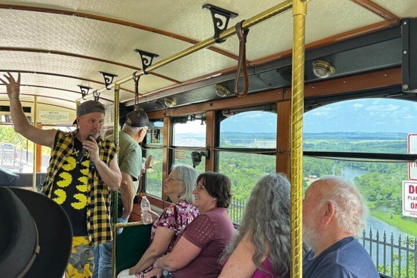 A bus interior with passengers and a driver. 1