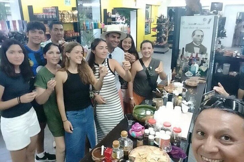 A group of people posing in a store with various products on display. 5