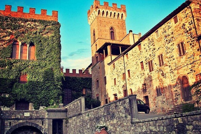 A historic stone building with ivy-covered walls and a tower. 4