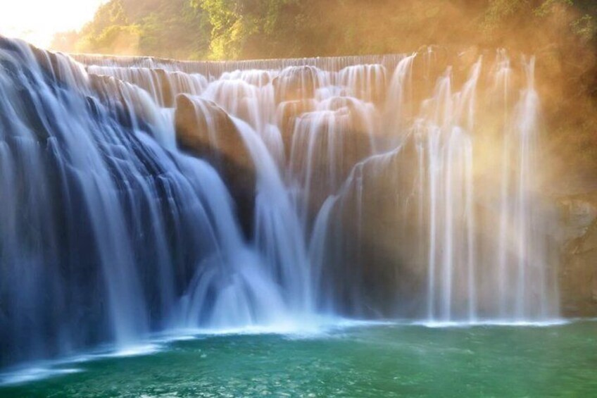 A waterfall cascading over a rocky cliff into a pool of water. 2