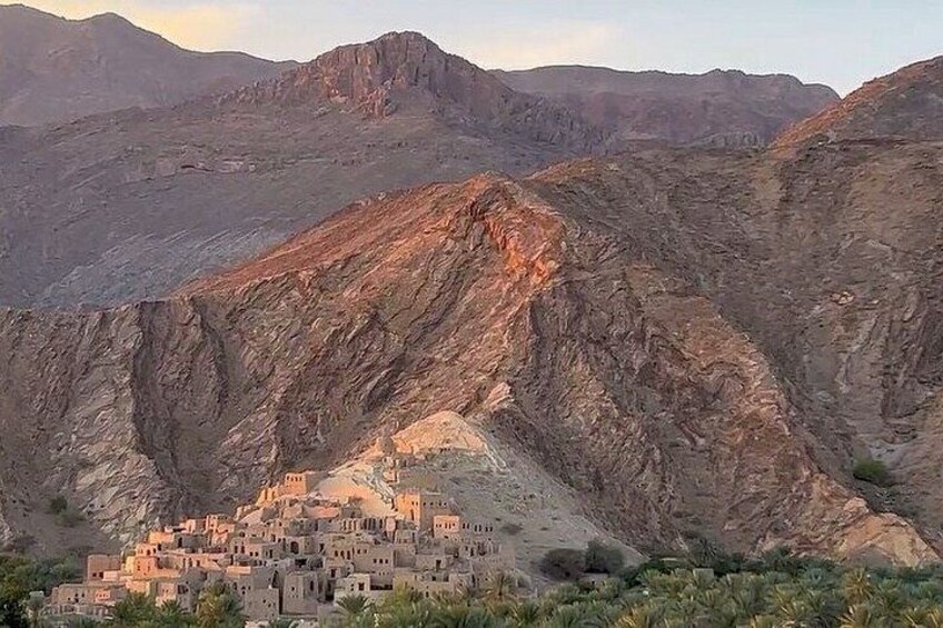 A mountainous landscape with a small settlement nestled in a valley. 5