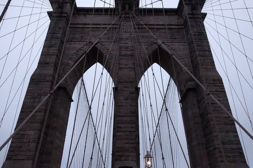 A large stone bridge with multiple arches and cables. 1