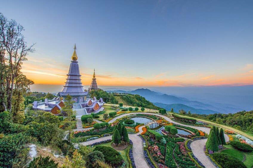 A temple complex with tiered pagodas, surrounded by manicured gardens and pathways. 1
