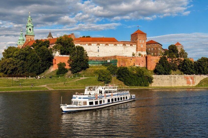 A river with a boat, a castle, and a green tower. 1