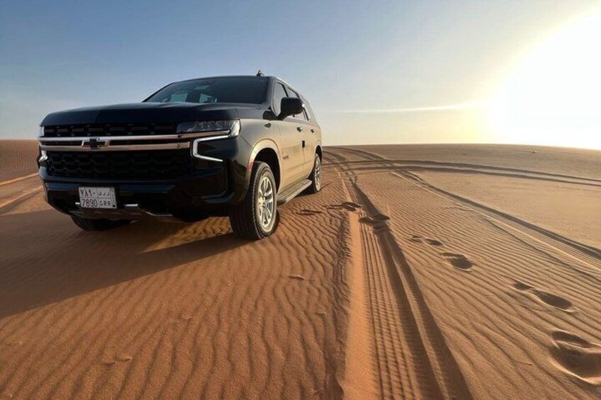 A vehicle on a sandy terrain with tracks. 4