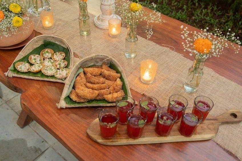 A wooden table with food and drinks, decorated with candles and flowers. 1
