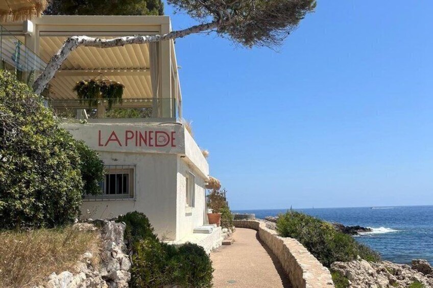 A coastal building named 'LA PINEDE' with a pathway leading to the sea. 3