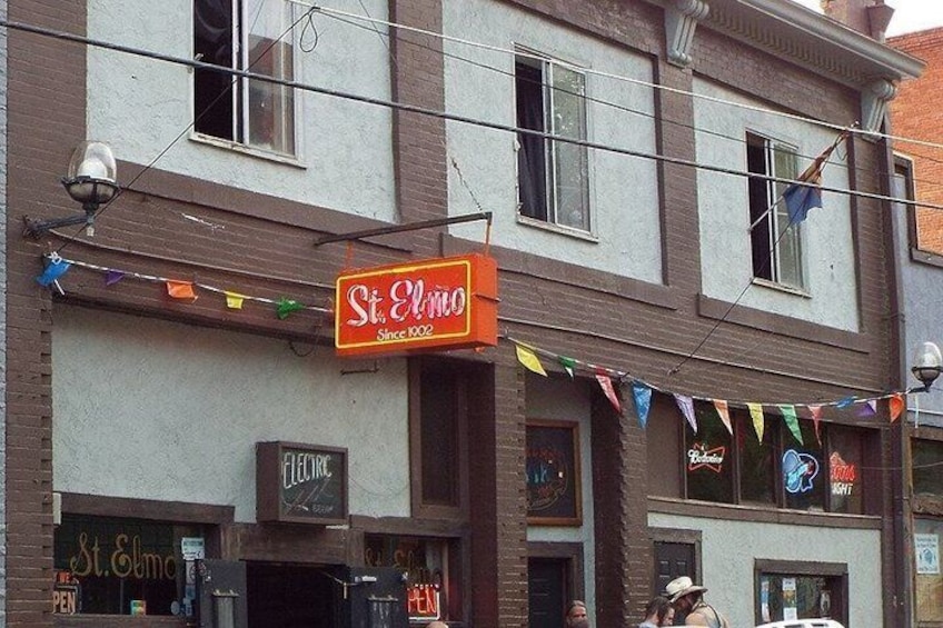A building with a sign that reads 'St. Elmo Since 1909.' 5