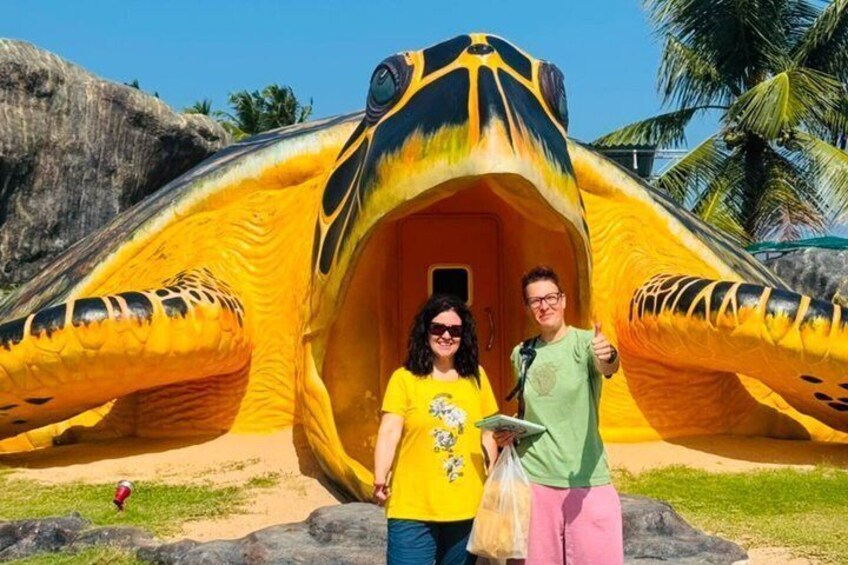 A large inflatable structure resembling a giant fish with an open entrance. 5