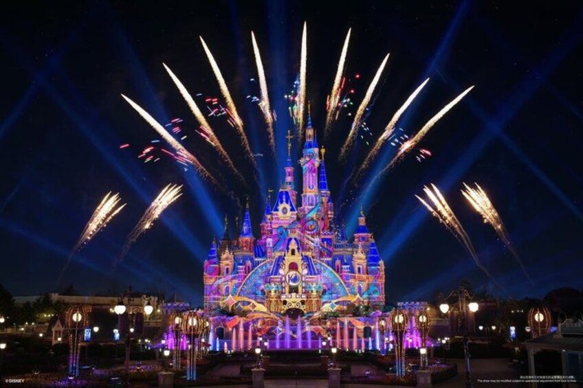 A brightly lit castle with fireworks. 5