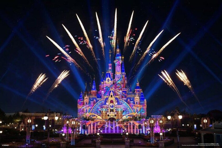 A brightly lit castle with fireworks. 3