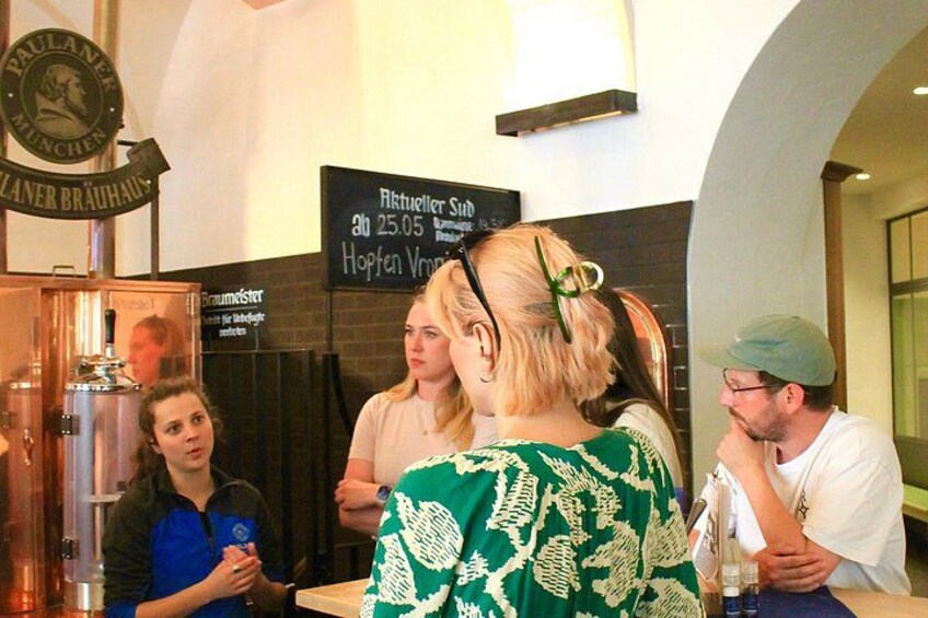 A bar area with a sign reading 'Paulaner Brauhaus' and a menu board. 4