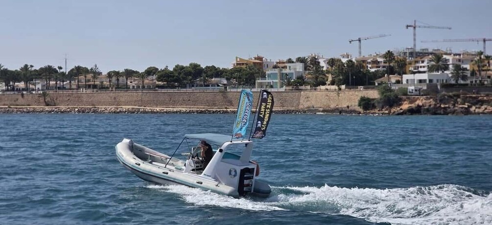A motorboat on water with a flag and a banner. 5