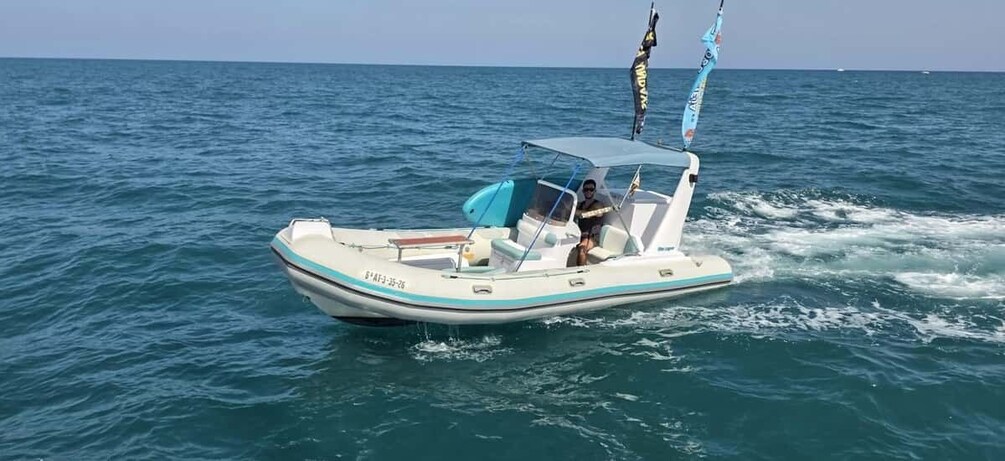 A small motorboat on the water with a blue canopy and two flags. 1