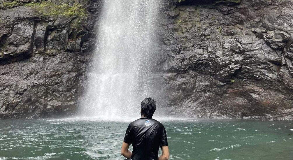 A waterfall cascading down a rocky cliff into a body of water. 3
