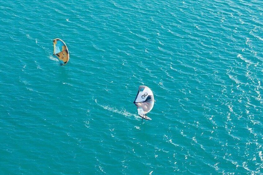Two windsurfers on turquoise water. 3