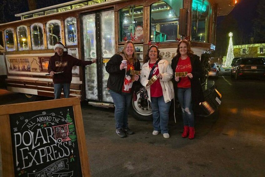 A food truck with a festive sign, a Christmas tree, and a sign that reads 'ALL ABOARD THE POAR EXPRESS.' 2