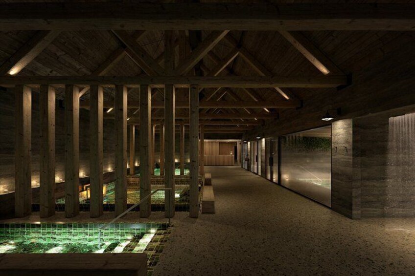An indoor swimming pool with wooden beams and a concrete wall. 3