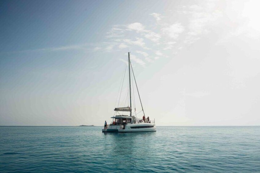 A sailboat on calm waters with a clear sky. 1