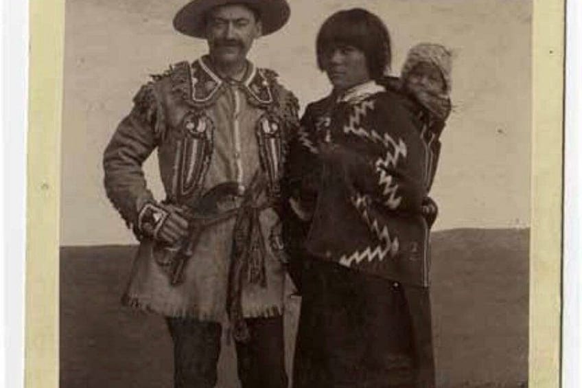 A person in a fringed coat and hat, another in a patterned dress, and a third in a hat and shawl. 2