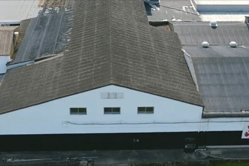 A building with a triangular roof and a white facade. 5