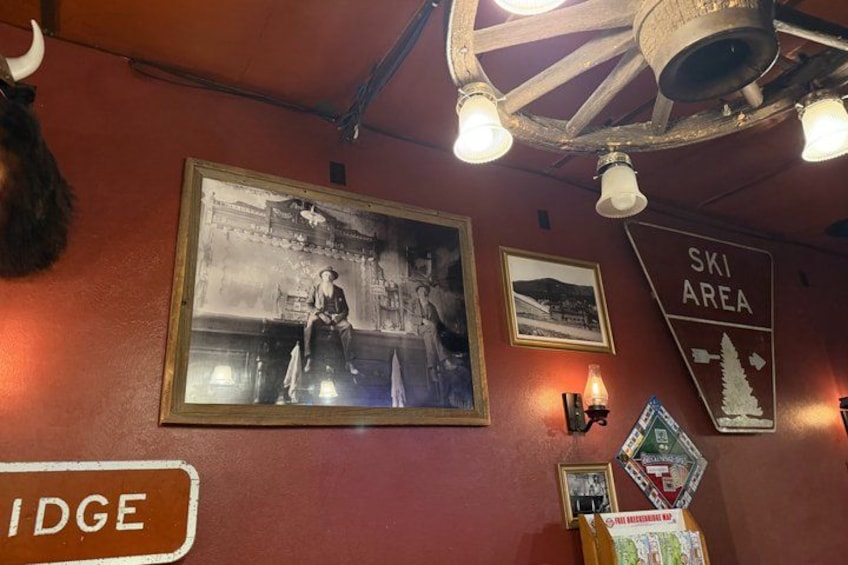 A wall with a large black and white photo, a 'Ski Area' sign, and a 'Bridge' sign. 2