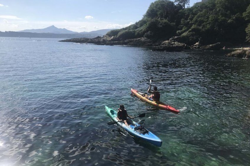 Two kayaks on calm water with a mountainous landscape in the background. 5