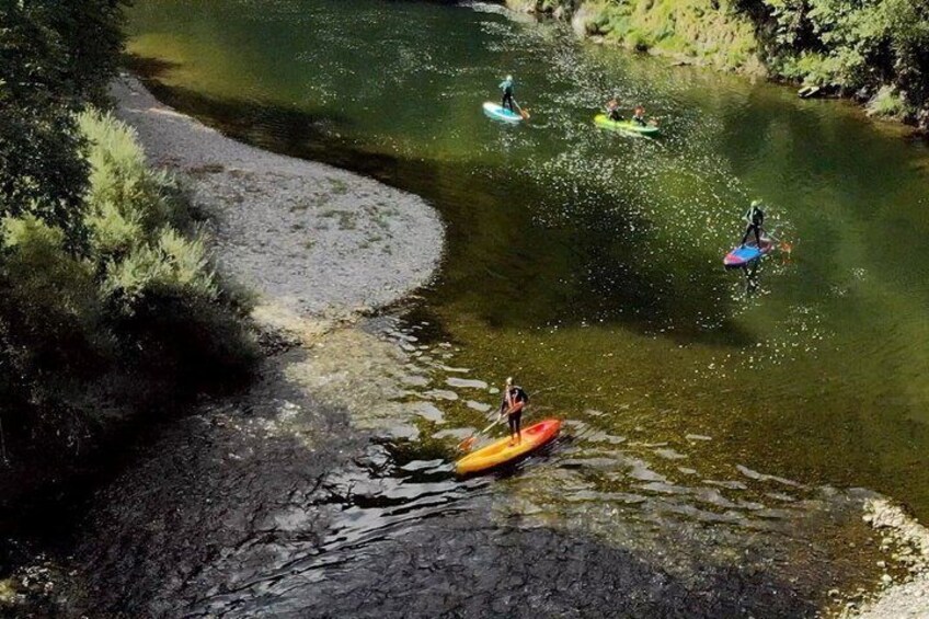 A river with kayakers and a canoe. 3